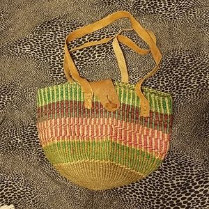 Vintage woven beach bag with leather straps.